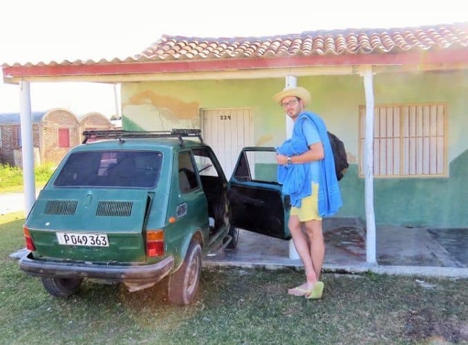 The author's husband posing with our ride to and from Playa Caletones.