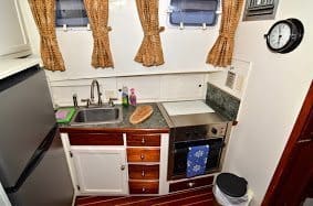 The compact galley, or kitchen in the boat allows you to prepare meals while staying on board.