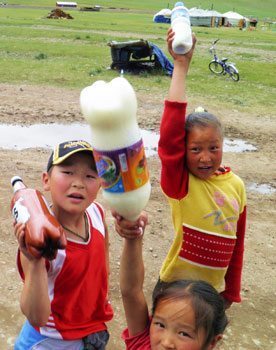 Kids selling fermented mare's milk in Mongolia