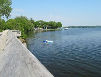 An early morning kayaker fishes on Rock Lake, on the edge of Lake Mills. 