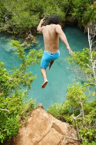 Jumping a cliff in Blue Hole Park in Tom’s Moore Jungle