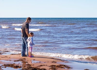 Father and daughter on the beach in PEI during the shellfish festival.