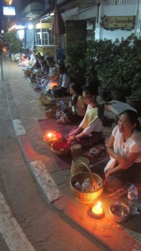 Monks lining the streets of Vientiane, Laos.