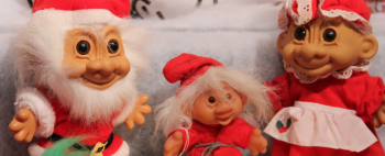 Some troll dolls dressed up for Christmas