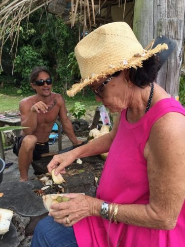 Frankie scoops coconut flesh from the shell after drinking the coconut milk.