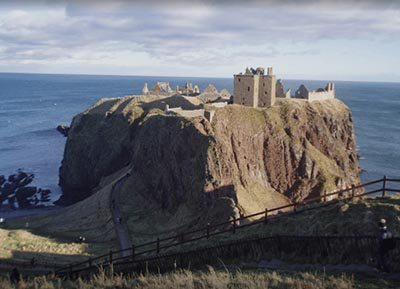 The fortress of Dunnottar, flanked by cliffs on three sides, viewed from the sole approach to the west.