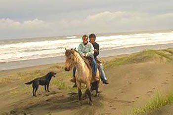 Riding a horse on the beach in Chiloe, Chile.