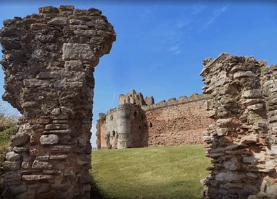Viewed through its foreworks, Tantallon Castle's massive curtain wall looms high.