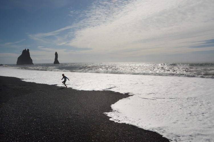 A child races the waves at Dyrholaey, Iceland. Monica Schimanke photos.