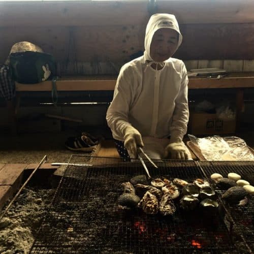 Ama grilling shellfish in an amagoya. Lauren Scharf photos.