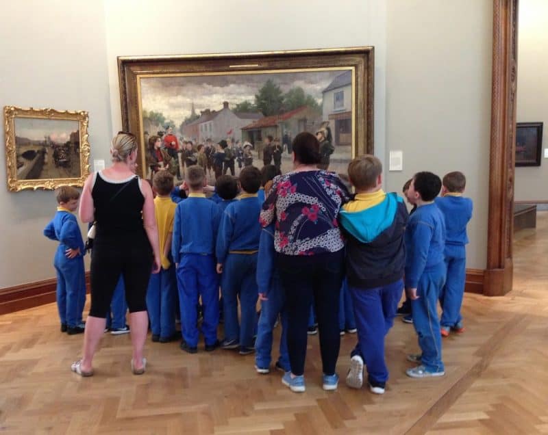 School children gather around an painting at the National Gallery in Dublin.