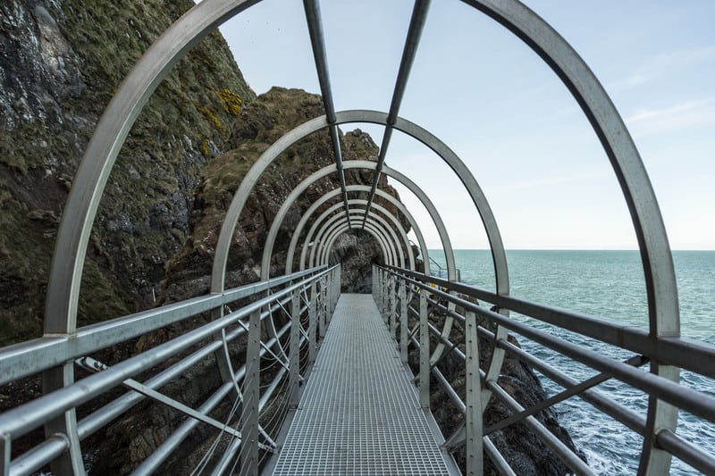 The Gobbins is a cliff walk of fantastical proportions. Bridges and tunnels carry you over crashing waves to sunken caves and sheer cliff faces.
