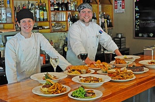 A couple of Traditions' chefs pose with some new delicious summer menu items. Photo courtesy of Purity Spring Resort