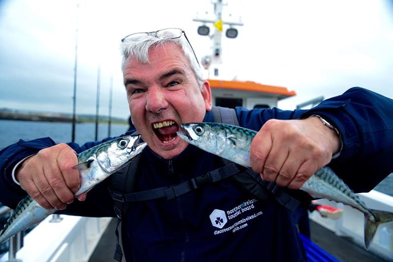 Northern Ireland Guide Billy Scott hams it up with two freshly-caught Mackerel on the Coastal Causeway. All photos by Sonja Stark.