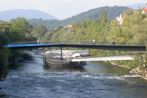 Right in the middle of the river Mur in Graz is a cafe and bar, accessible by bridges on either end.