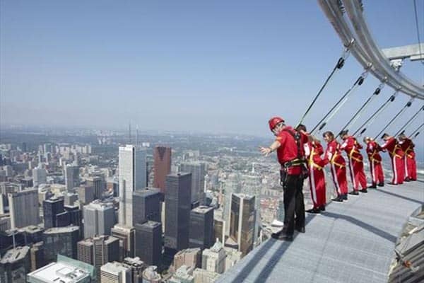 CN-Tower Toronto: if you are daring enough, you can hang off the edge like these guys are doing!