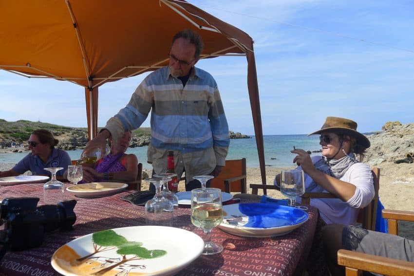 Yves Courrier from the Bordeaux, France, region, and Catalina Florit, our guide, relax by a beachside picnic site set up by the support crew.