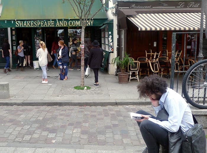 Reading the Bard in front of Shakespeare and Company bookstore, in Paris.