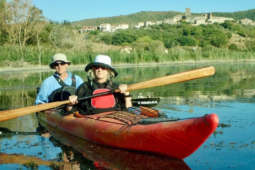 The author and her husband Peter Petre on Lake Trasimeno. In the background is the village of San Savino, inhabited since the Etruscan period. Photo by Allison Thiel.