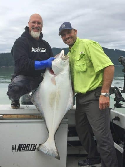 John Yeager, owner of Alaska Charters and Adventures, holding Pike Pickett’s 40-pound halibut