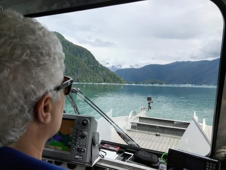 Sylvia Ettafagh, Fisheries Biologist and woner of Alaska Vistas, approaching icebergs in LeConte Bay.