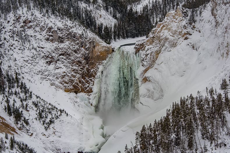 While it creates a notable roar in the warm season, The Lower Falls of the Grand Canyon of Yellowstone becomes a silent frozen beauty in the winter months.