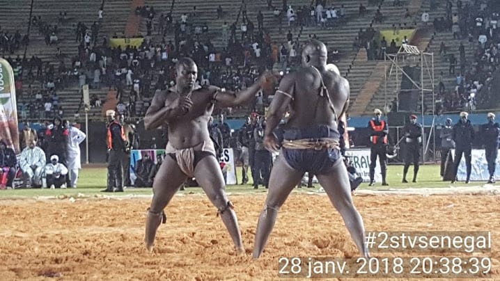 Fighters get ready to grapple in the dirt ring in Senegal.