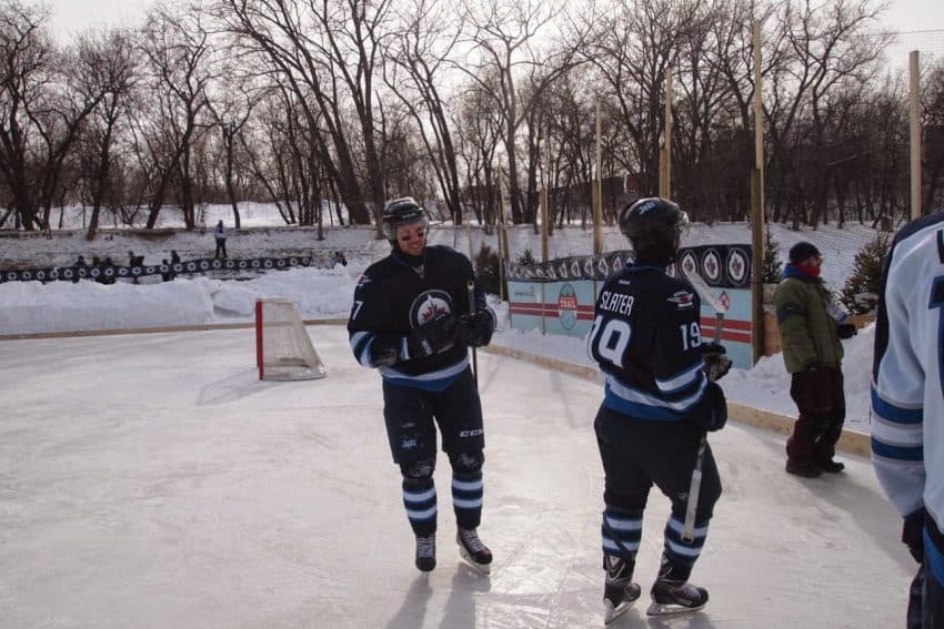 Members of the Winnipeg Jets at a practice game held on the river. 