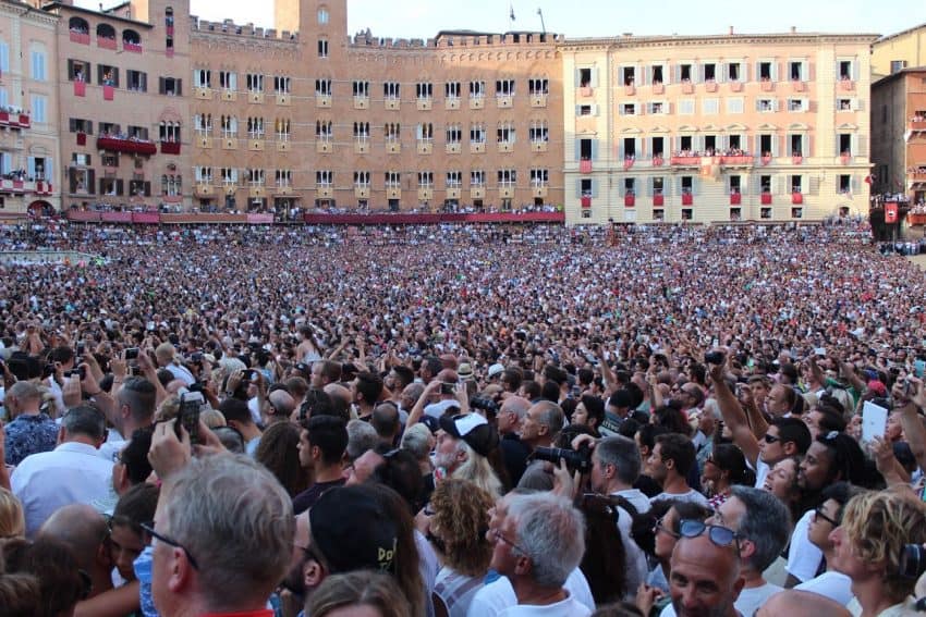The race is on! Spectators from all corners of the globe crane their necks in unison to follow the excitement of the Il Palio horse race in Siena, Italy. Eric Sweigert photos.