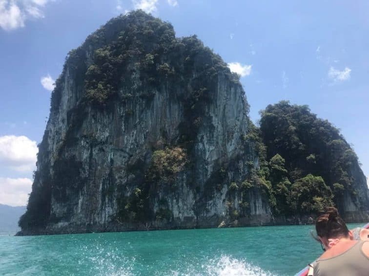 Rainforest-covered limestone mountains in Chiaw Laan Lake, Thailand. | GoNOMAD Travel