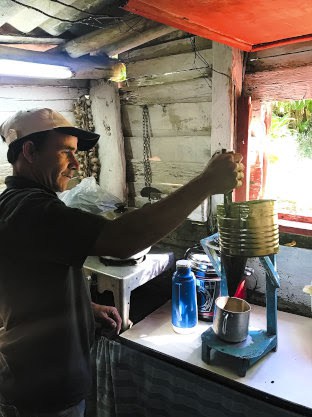 Coffee farmer Masiel brews coffee for visitors in his kitchen in Trinidad, Cuba | GoNOMAD Travel