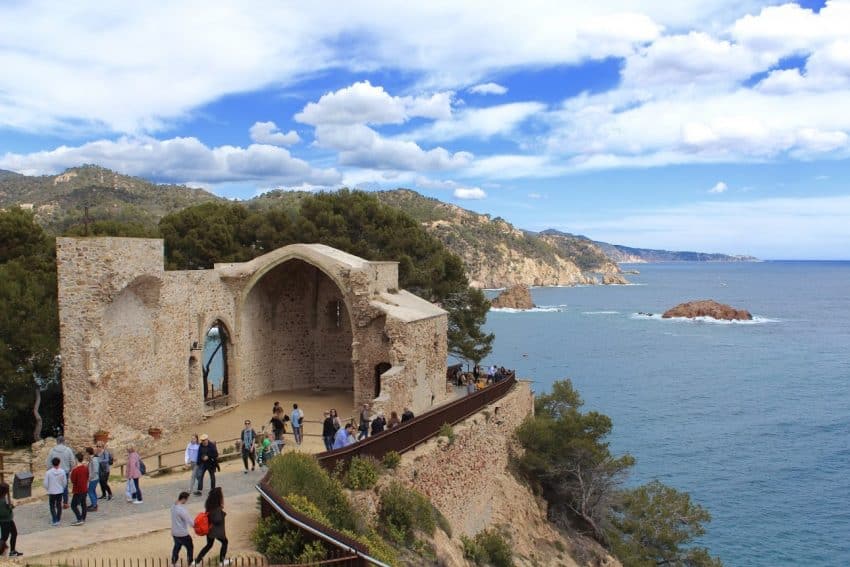 A winding path leads sightseers into and up the old, walled-town of Tossa de Mar in a remote section of the Costa Brava.