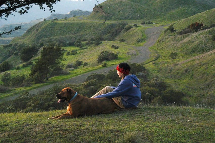 Relaxing with a friend on the green hills in Oakland, California.