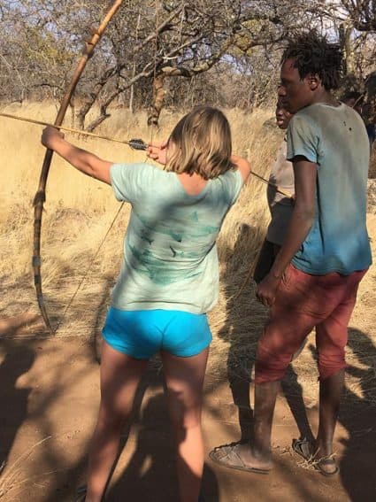 Learning to shoot a bow and arrow from a master.