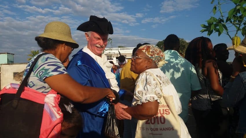 Punta Gorda residents greet the local actor who played the "British official" in the annual historic portrayal of Garifuna Settlement Day on the pier in Punta Gorda, Belize.