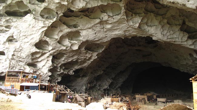 In Guizhou, China, there is a small village of 64 people who live in a cave.
