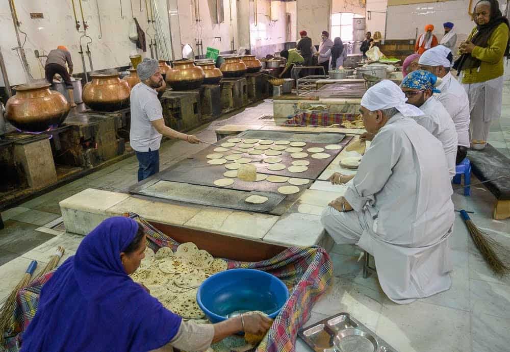 Chapati, a form of unleavened bread and a staple in the Indian diet, is cooked on large griddles until brown spots appear.