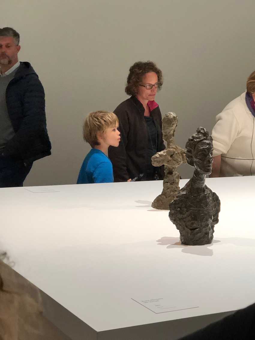 At the Lille Museum of Modern Art, a young boy listens with intense interest in a lecture about Alberto Giocometti
