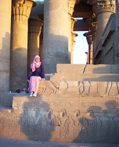 Most Egyptian women wear artfully draped headscarves. This girl poses on a temple wall at Luxor.