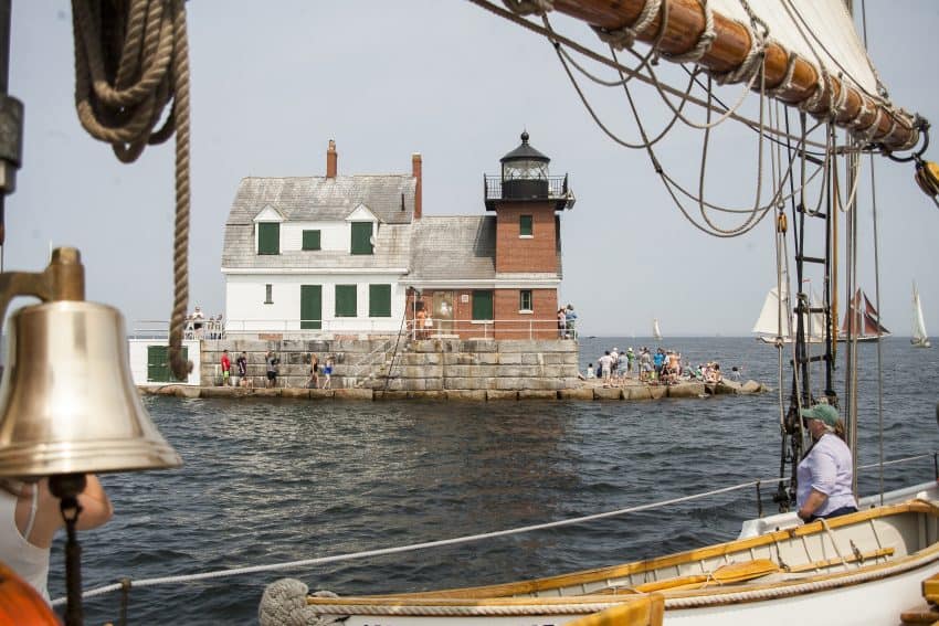 A crowd cheers the schooners on at the Rockland Breakwater Lighthouse, Rockland Maine.