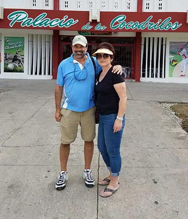 Jay Smith and a traveler in front of one of Cuba's baseball stadiums on a Sports Travel and Tours trip to the island in 2016.