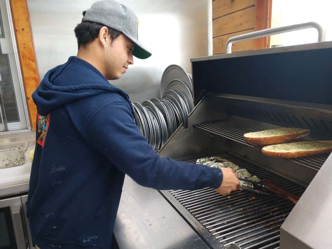 An employees grilling oysters at Marshall's Store in Tomales Bay.