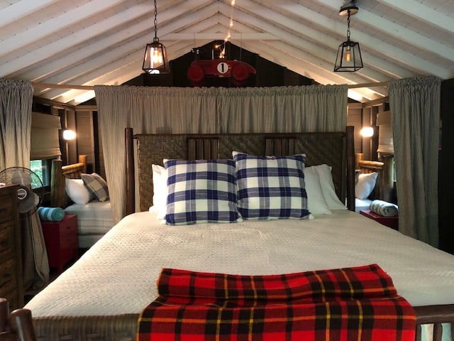 Some of the modern safari-style cabins at Sandy Pines feature beds for kids behind the main bed. Perfect for family camping.