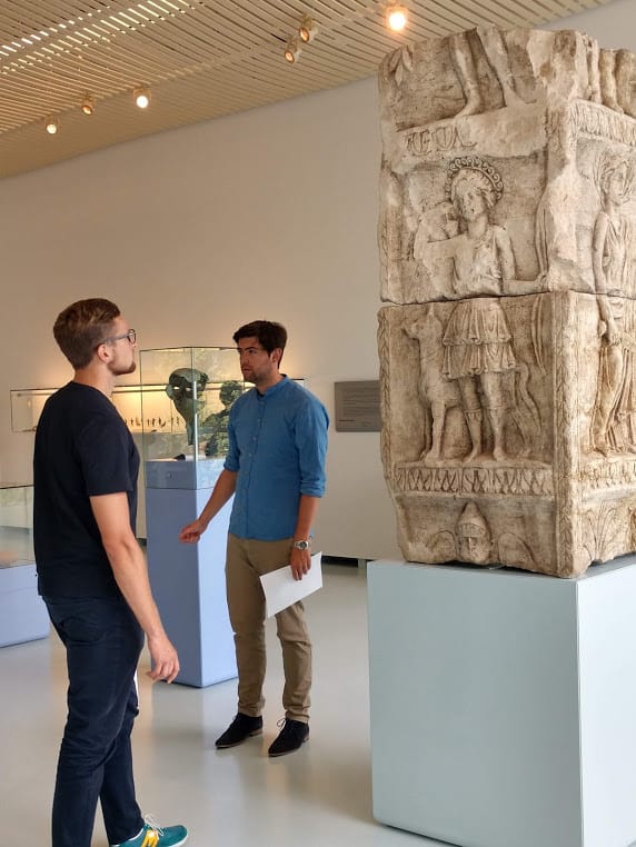 Visitors to the Valkhof Museum study an ancient Roman column that had been buried for centuries in the ground around the city.