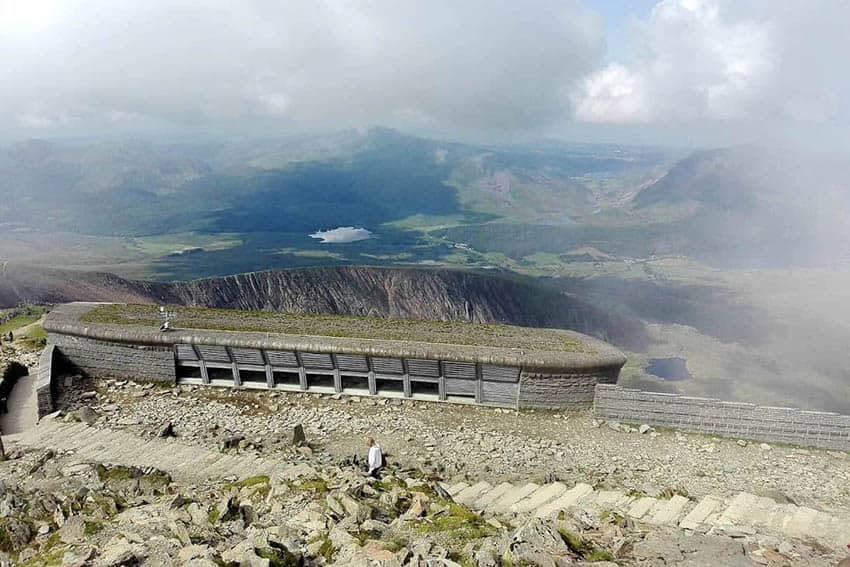 At the summit of Snowdon with a shot of its visitor centre amongst the Snowdonia grandeur.