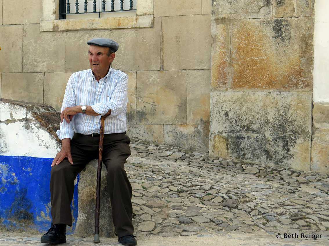 A man rests outside the main city gate