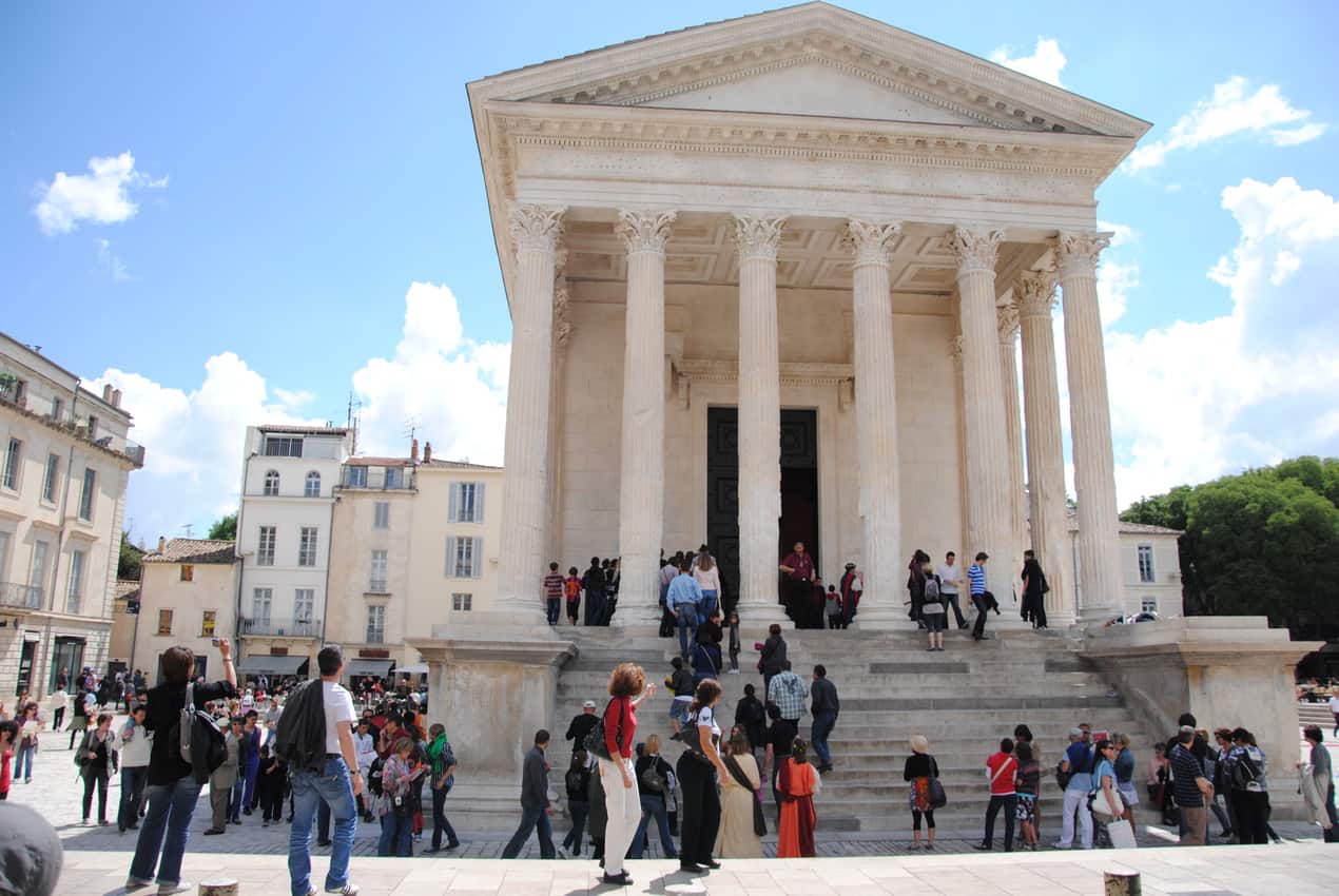 The Maison CarrÇe is a former forum and ancient surviving structure of Roman civilisation in a busy square in Nimes.