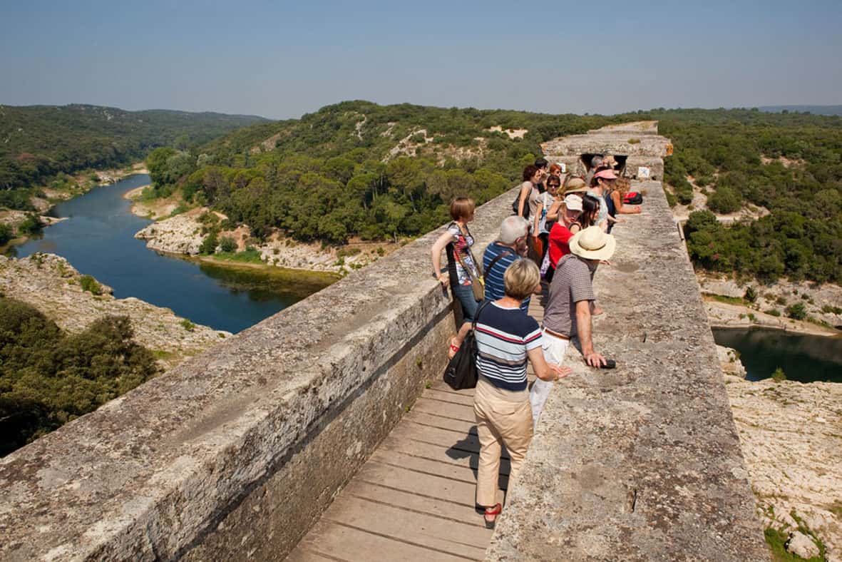 Tourists on top of the Roman aqueduct at Pont du Gard near Nimes.