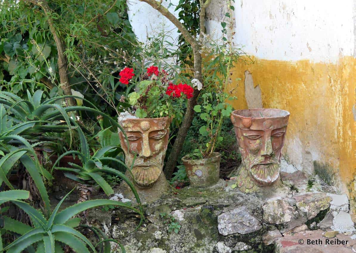 Unusual pots outside a private garden in Obidos Portugal