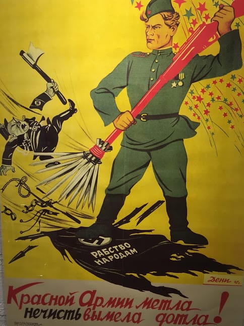 A Soviet propaganda poster showing the Nazis being swept out